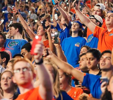 students holding phone light in the stadium