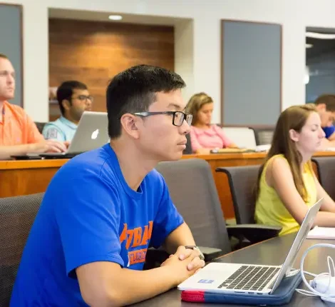 Students sitting and listening in a classroom.